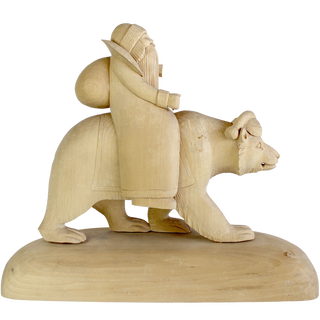 A wooden sculpture depicting a bearded figure riding a bear.