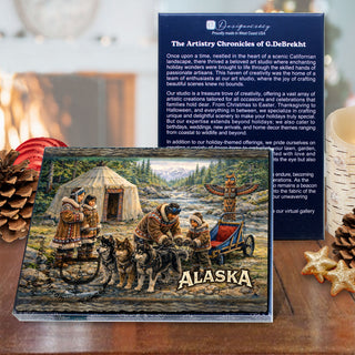 a wooden table with a framed painting of a group of people in traditional clothing, a pine cone, and some star-shaped cookies.
