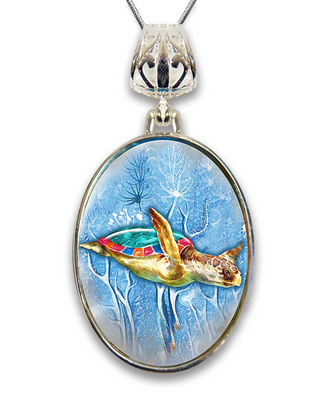 A pendant featuring a colorful painting of a sea turtle swimming in the ocean.
