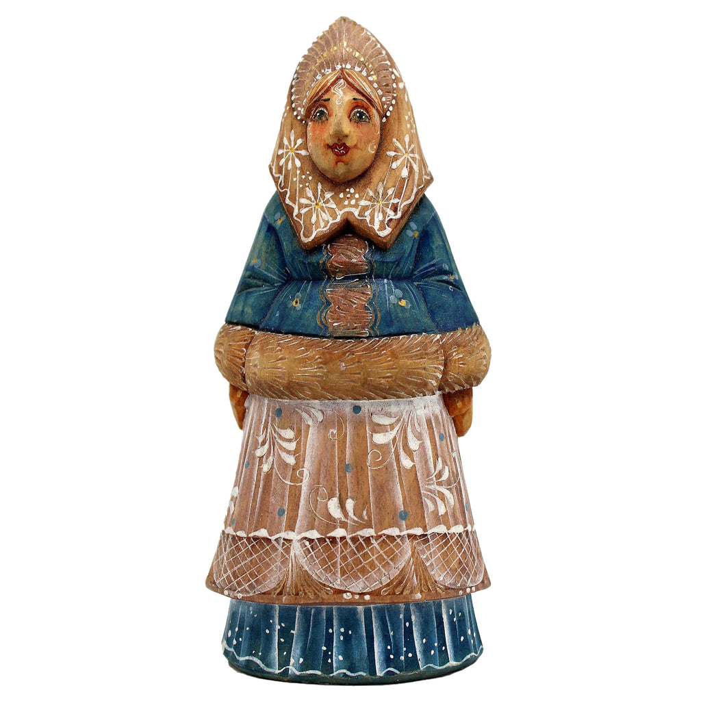 A wooden figurine depicting a woman wearing a blue dress with a white floral pattern and a headdress.