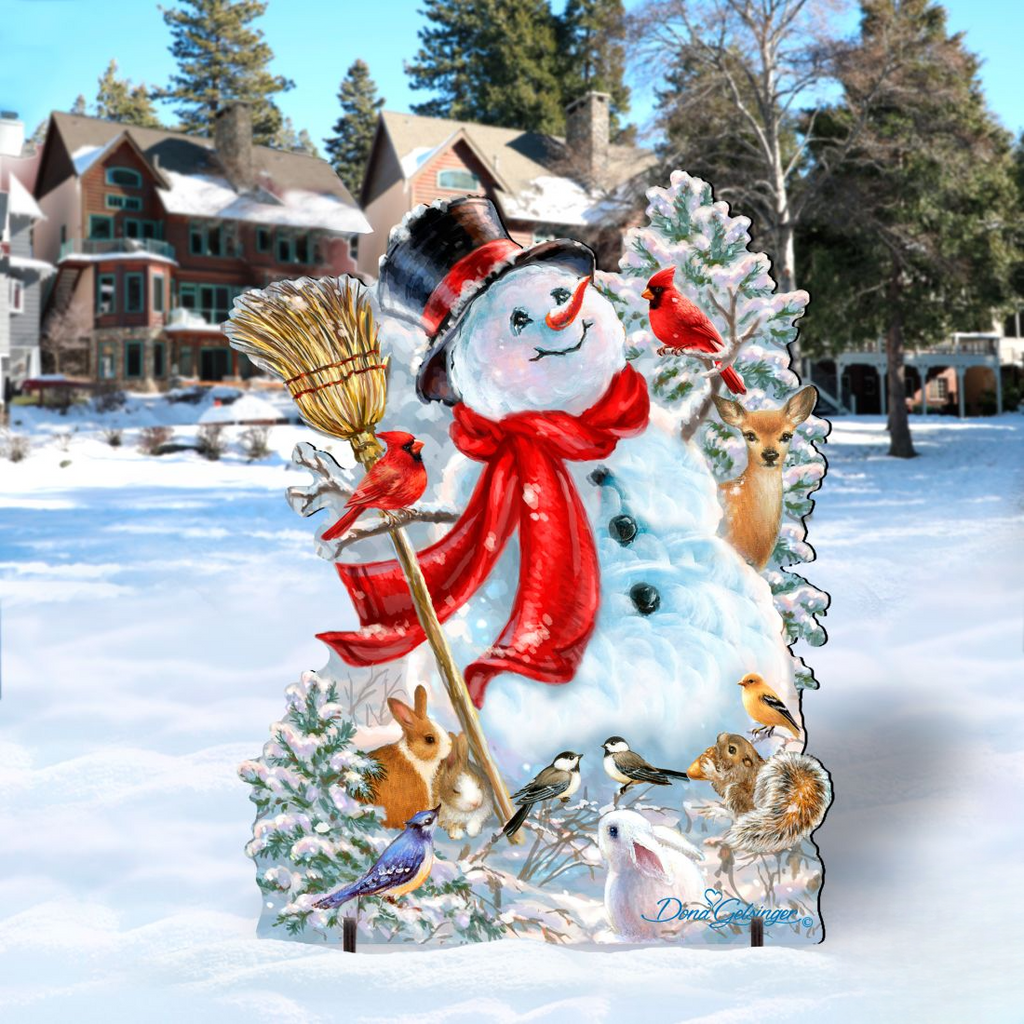 A snowman decorated with various animals, including a red scarf, a broom, and a bird, stands in a snowy landscape with houses and trees in the background.
