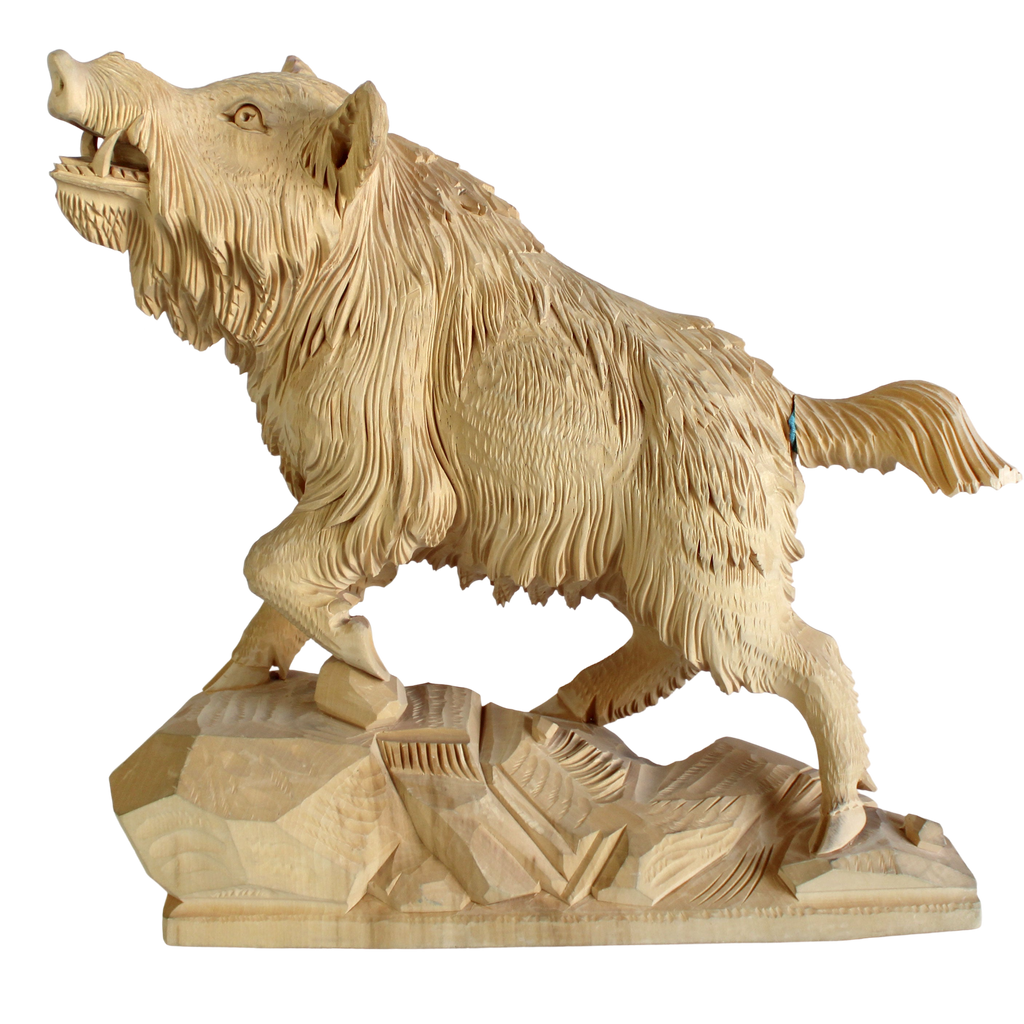 A wooden sculpture of a fierce-looking animal, possibly a bear or a wolf, standing on a rock.