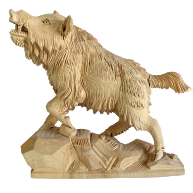 A wooden sculpture of a fierce-looking animal, possibly a bear or a wolf, standing on a rock.