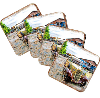 A set of four coasters featuring a vintage car on a dirt road, with a rustic building in the background.