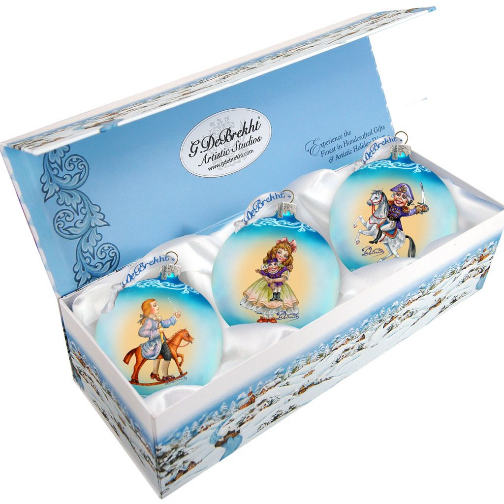 A set of three Christmas ornaments in a blue box, each featuring a different illustration.