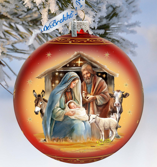 A red Christmas ornament with a nativity scene depicting the Holy Family of Jesus, Mary, and Joseph, along with animals such as a donkey and a sheep.