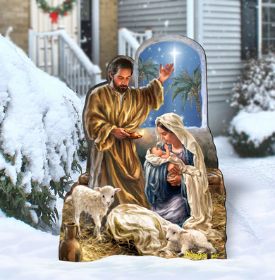 A cardboard cutout depicting the nativity scene of the birth of Jesus Christ, with a man, a woman, and a baby in a snowy landscape.