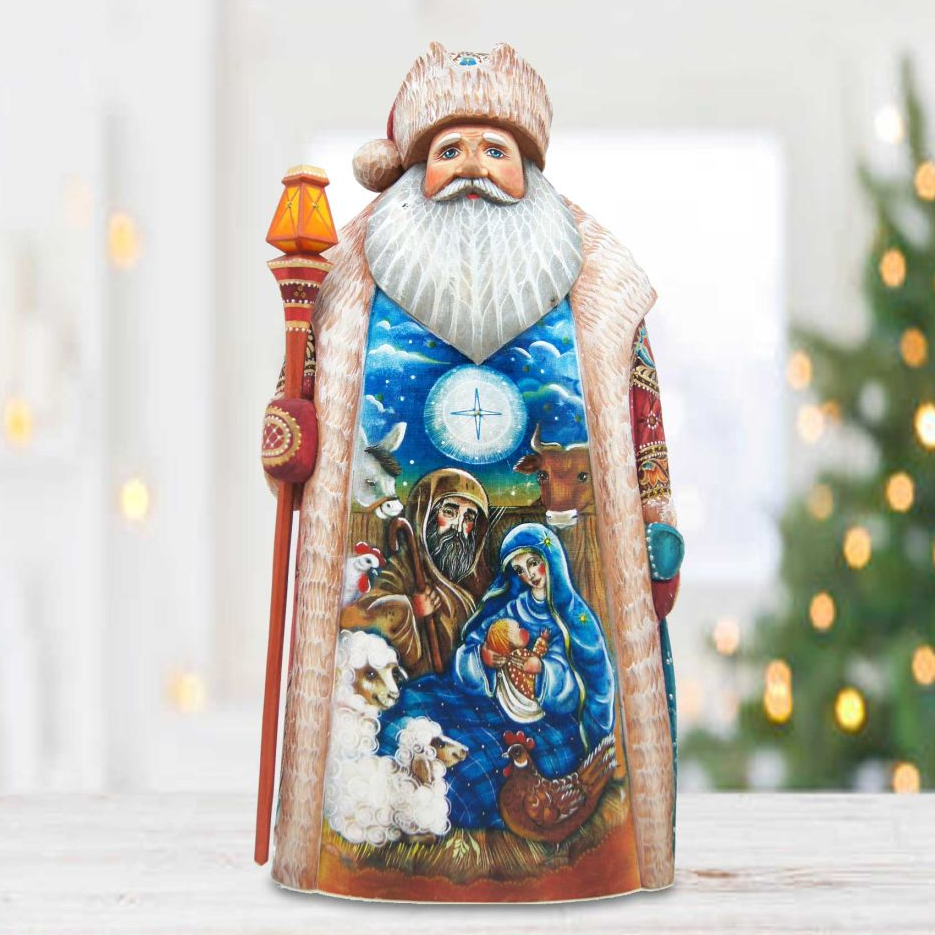 A figurine of Santa Claus holding a lantern and surrounded by various religious figures, including the Virgin Mary and baby Jesus, in a nativity scene.