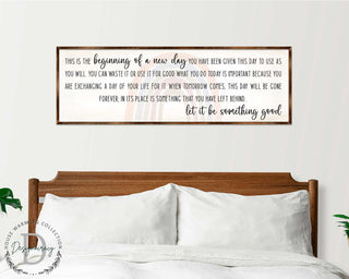 a wooden headboard with a framed inspirational quote above it, which reads: 