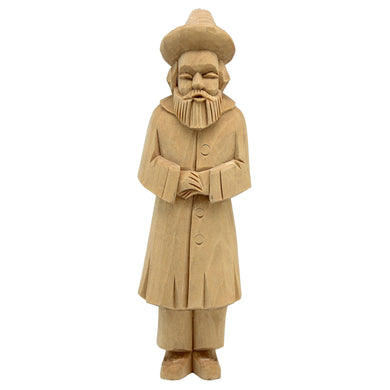 A wooden statue of a bearded man wearing a hat and coat, standing upright and facing forward.