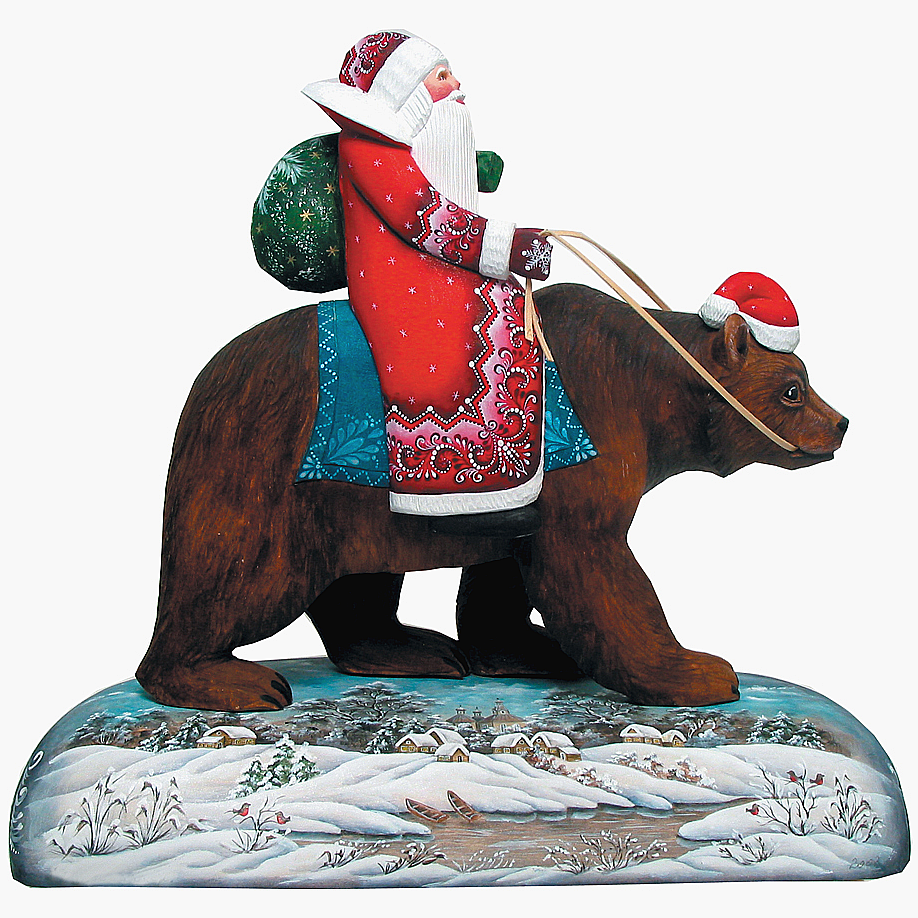 A statue of Santa Claus riding a bear, with a snowy landscape in the background.