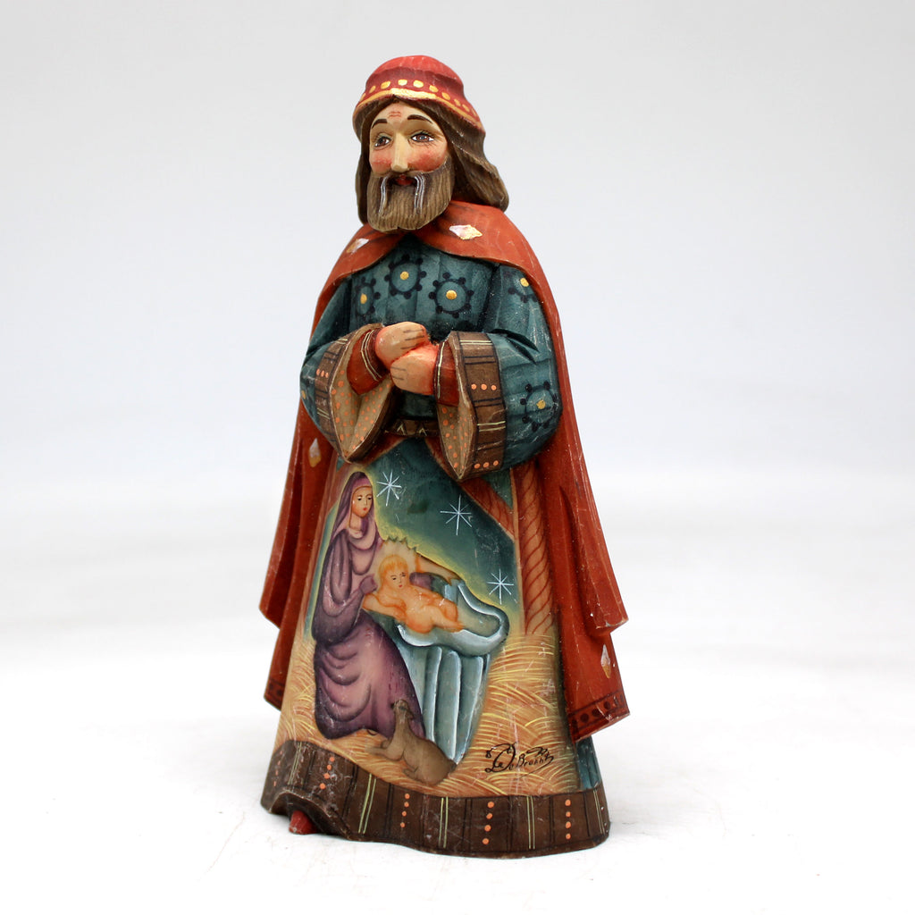 a figurine of a man with a beard and a red cape