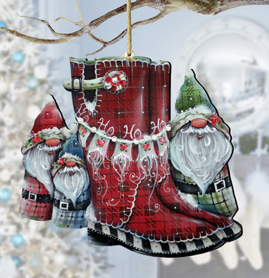 A red plaid boot ornament with three gnome-like figures wearing plaid outfits and hats, hanging from a branch.