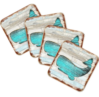 four square coasters with a blue whale design on them.