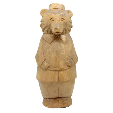 A wooden sculpture of a bear wearing a top hat and coat, standing upright and facing forward.