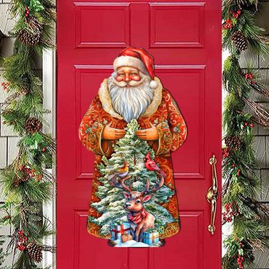A large, colorful cardboard cutout of Santa Claus holding a Christmas tree and presents is displayed on a red door.