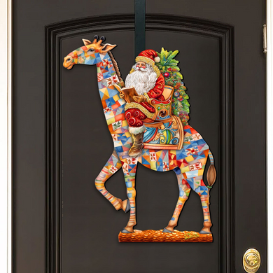 A colorful, mosaic-style decoration of Santa Claus riding a giraffe on a decorated horse, hanging on a door.