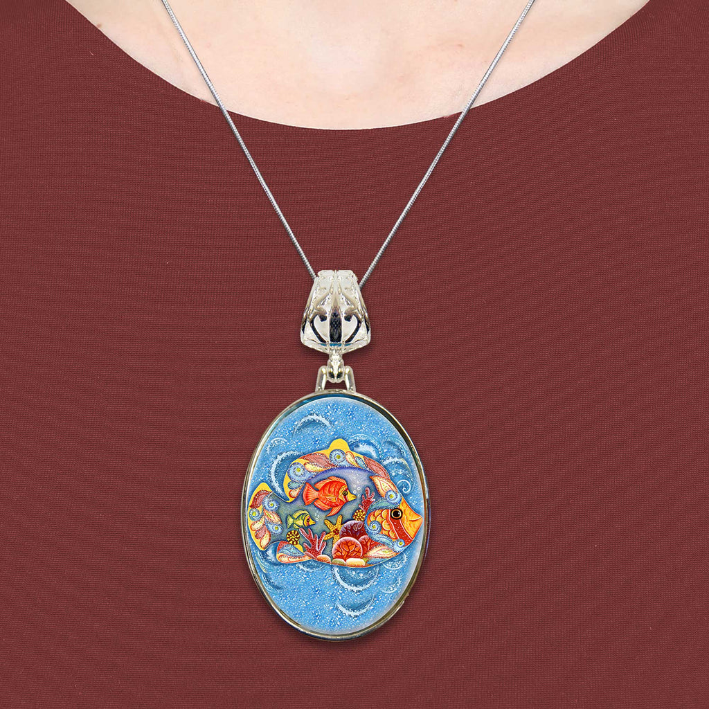 A necklace with a pendant featuring a colorful, circular design of fish and other aquatic elements.