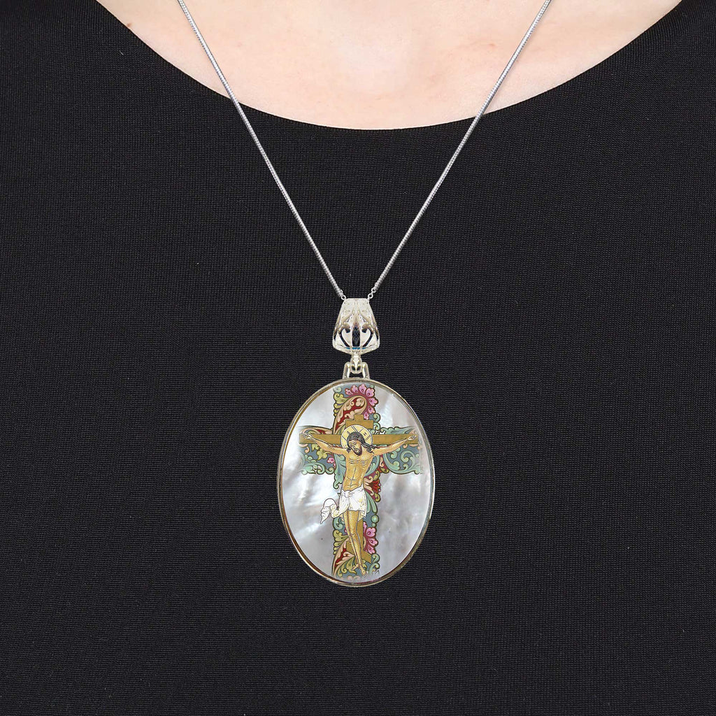 A necklace with a pendant featuring a religious figure, likely Jesus Christ, depicted in a circular design.