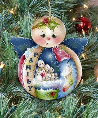 A colorful ornament with a family theme, featuring a snowman, snowmen, and a holly leaf, hanging on a Christmas tree.