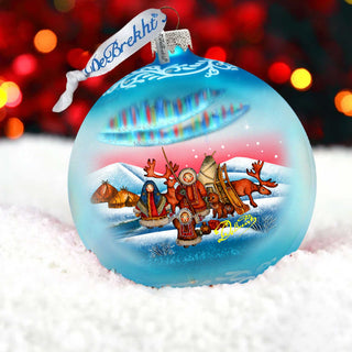 a glass ornament with a christmas scene on it