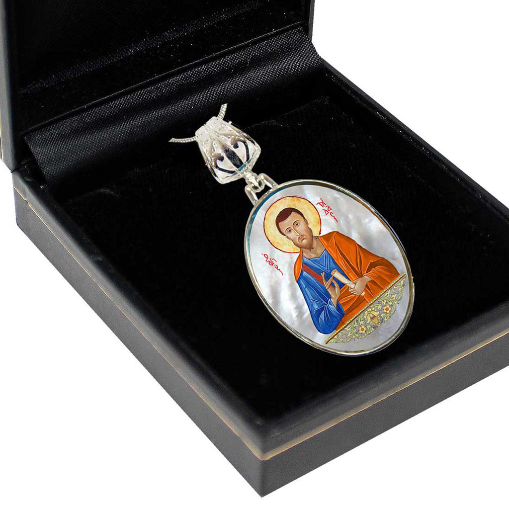 A pendant in a black box, featuring an image of a religious figure.