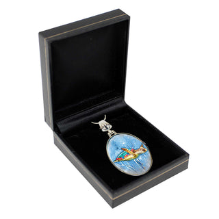 A pendant with a colorful design is displayed in a black jewelry box.
