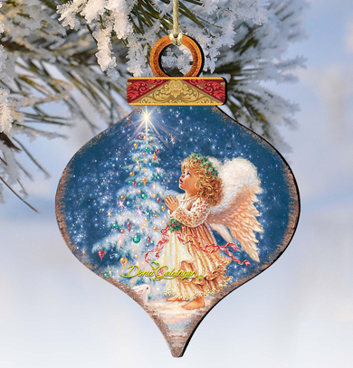 A wooden ornament with a painted image of an angel in a snowy landscape, gazing up at a starry night sky.