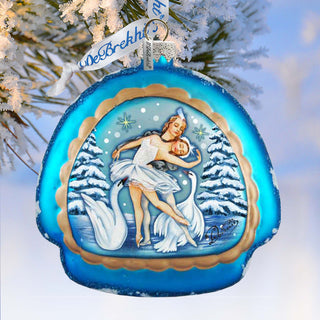 A blue ornament with a white swan and snowflakes, featuring a woman in a white dress dancing with the swan.