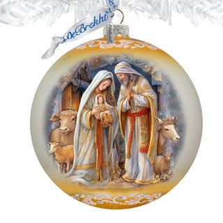 A decorative Christmas ornament featuring a nativity scene with the Virgin Mary, baby Jesus, and the saints.