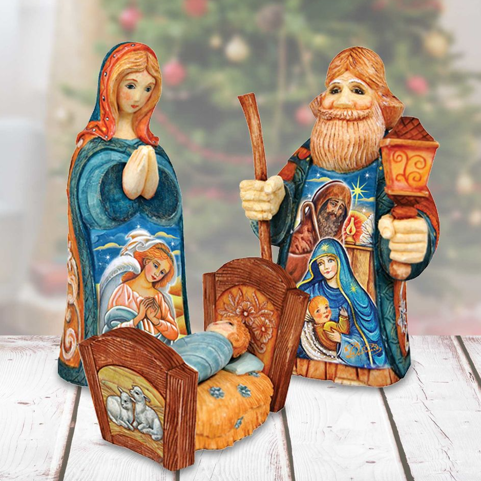 a nativity scene with three wooden figurines representing the baby Jesus, Mary, and Joseph, each holding a different object. The figurines are set against a blurred background, likely a Christmas tree, creating a festive and religious atmosphere.