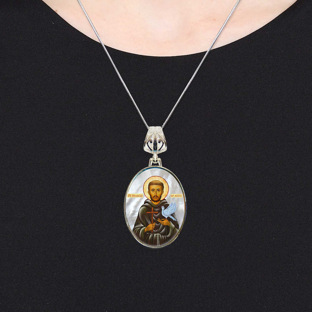 A silver necklace with a pendant featuring a religious icon of a saint.