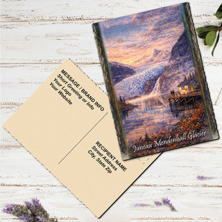 a postcard with a scenic mountain landscape and a waterfall, along with a blank message card.