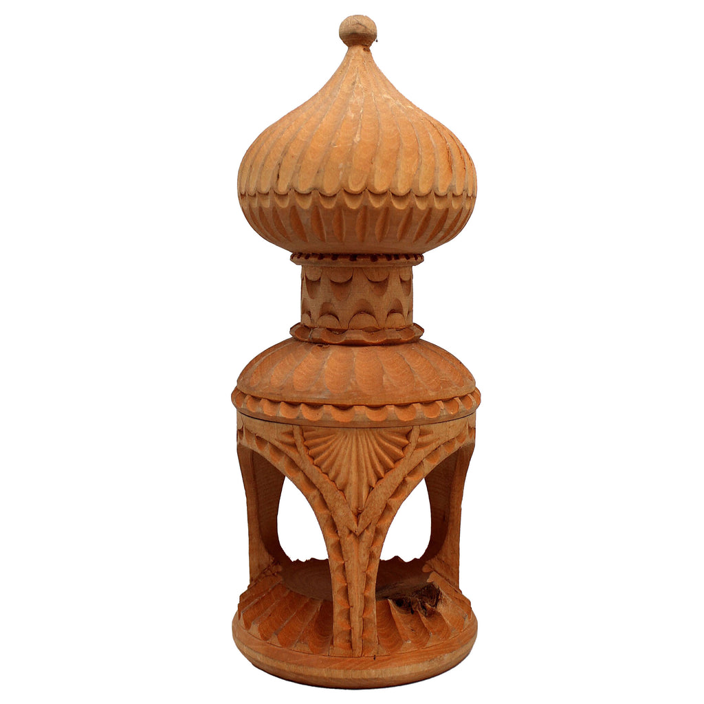 a wooden sculpture with a domed top and intricate carvings on the base.