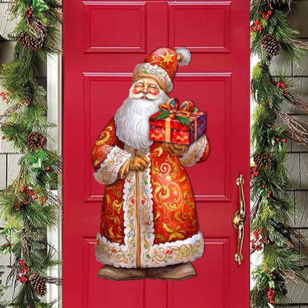A red door with a Santa Claus figure holding a gift box, surrounded by Christmas decorations such as pine cones and berries.