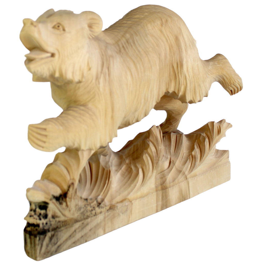 A wooden carving of a bear in mid-stride, with its mouth open and legs spread, is depicted on a wooden base.