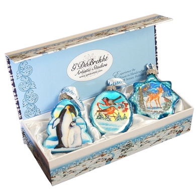 A set of three decorative ornaments in a box, each featuring a different animal and winter scene design.