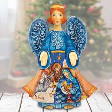 A hand-painted wooden angel figurine with blue wings and a blue dress, featuring a nativity scene with a baby Jesus, Mary, and Joseph.
