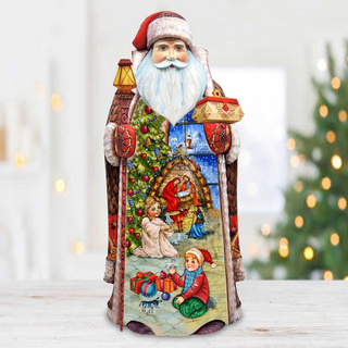 A colorful, hand-painted Christmas ornament depicting Santa Claus and children in a winter scene, with a decorated Christmas tree in the background.