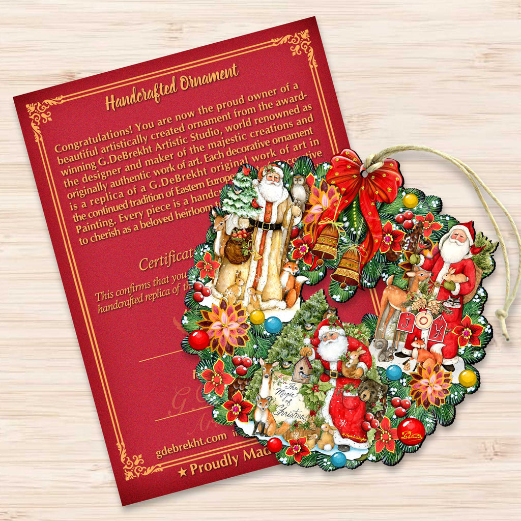 a handmade ornament with a wreath and various Christmas-themed decorations, including Santa Claus and other holiday characters. The ornament is placed on a wooden surface next to a red card with text and a certificate.