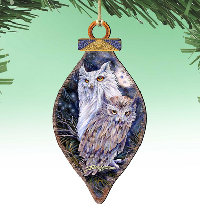 A decorative ornament featuring two owls, one larger and one smaller, against a night sky background.