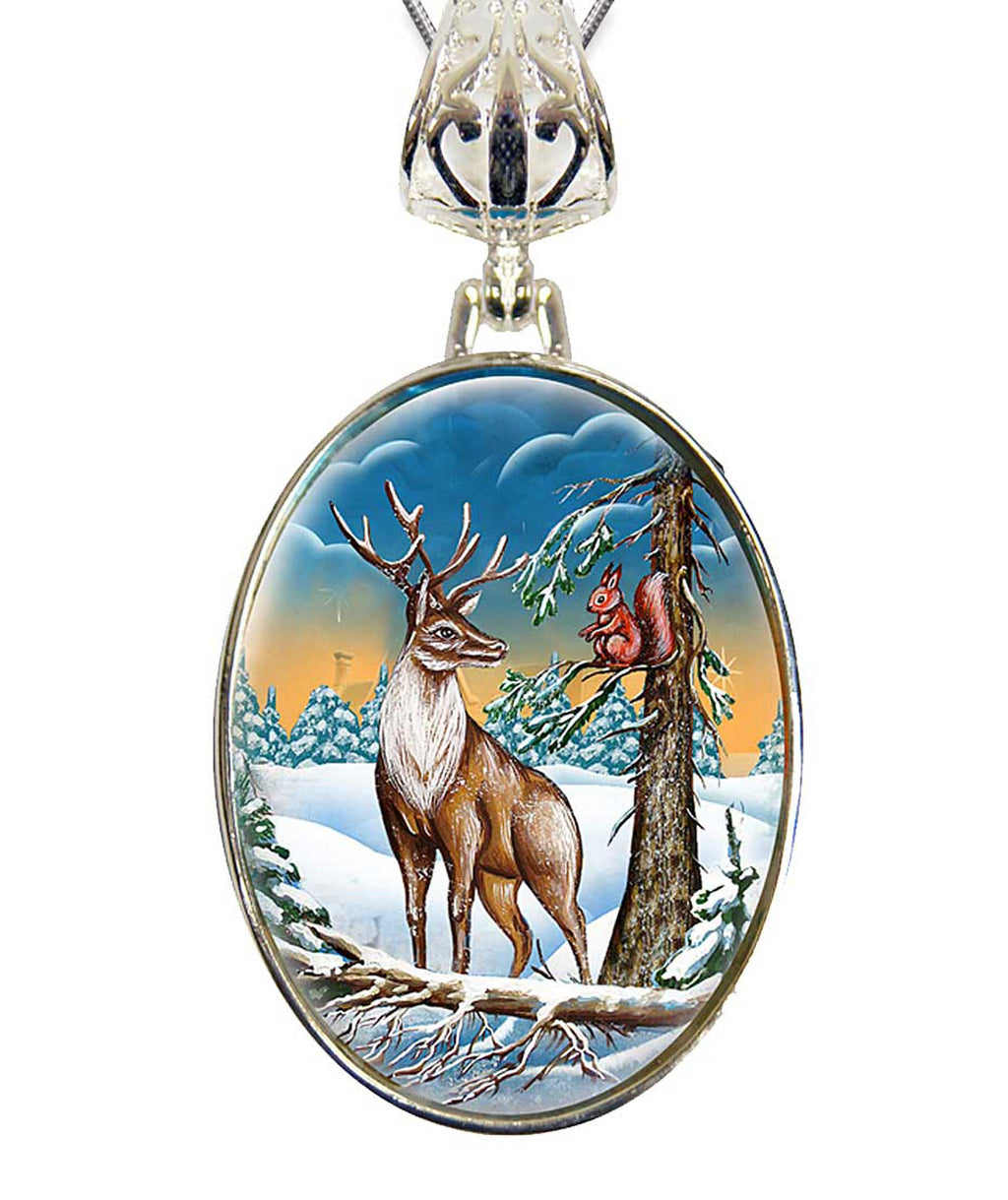A pendant featuring a deer standing in a snowy forest with a squirrel perched on a tree branch.