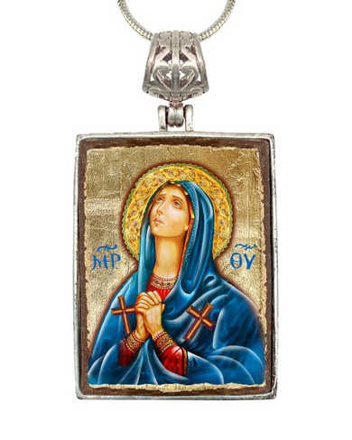 a religious icon of a woman wearing a blue robe and holding a cross, with a halo around her head.