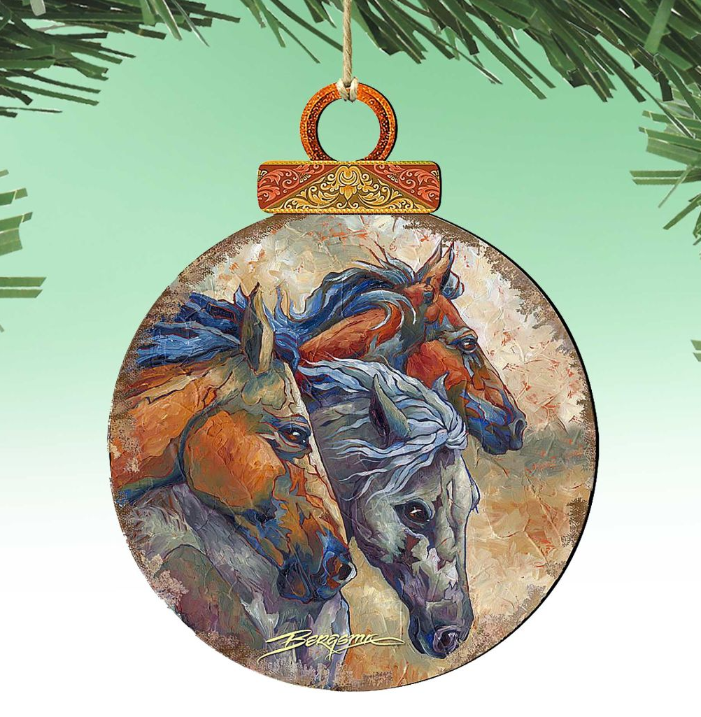 A round ornament featuring a painting of three horses, with a wooden frame and a decorative top.