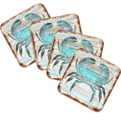 four square coasters with a blue crab design on them.