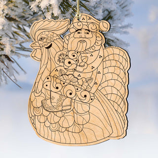 A wooden ornament depicting a rooster and a Santa Claus figure, hanging on a tree branch.