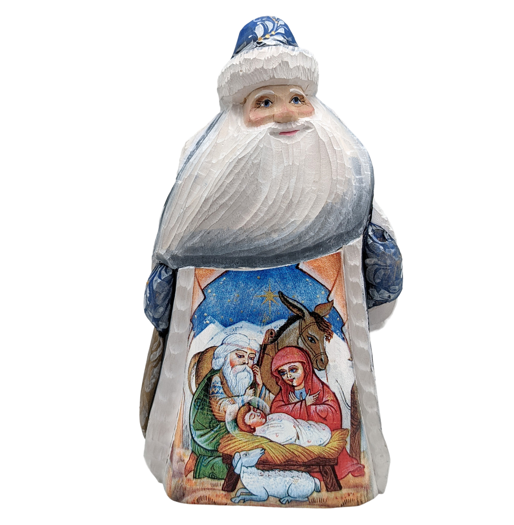 A carved wooden Santa Claus figure with a nativity scene depicted on its back.