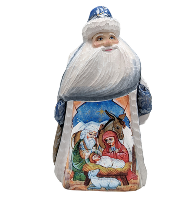 A carved wooden Santa Claus figure with a nativity scene depicted on its back.