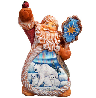 A figurine of Santa Claus holding a bird and a star, with a scene of polar bears and a blue sky visible inside the figurine.