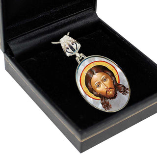 A pendant with a religious icon, likely a depiction of Jesus Christ, is displayed in a black box.
